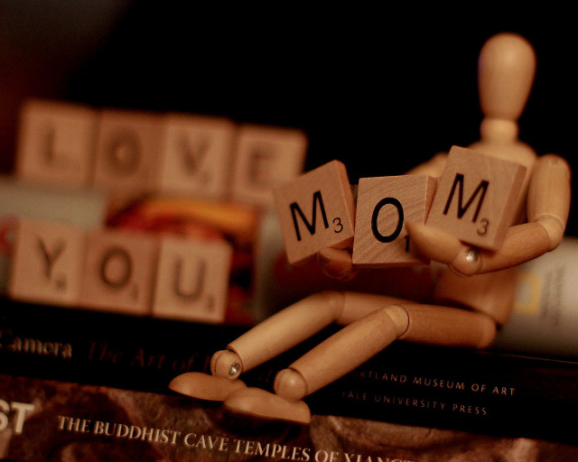 Wooden man holding block mom free wallpaper - medium preview image