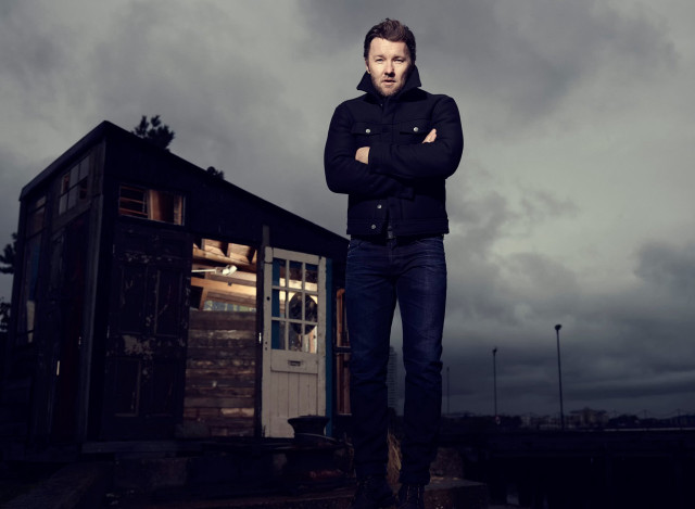Man standing shack cloudy arms free wallpaper - medium preview image