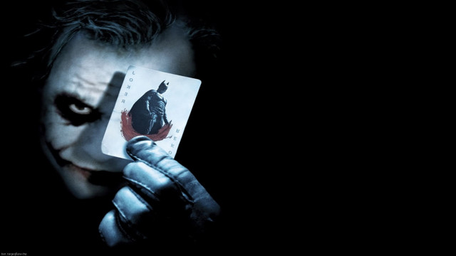 Man holding card joker face free wallpaper - medium preview image