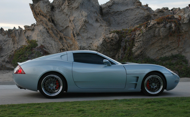 Silver sports car rock formation free wallpaper - medium preview image