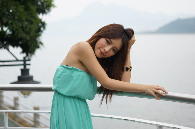 Woman green dress water railing free wallpaper - medium preview image