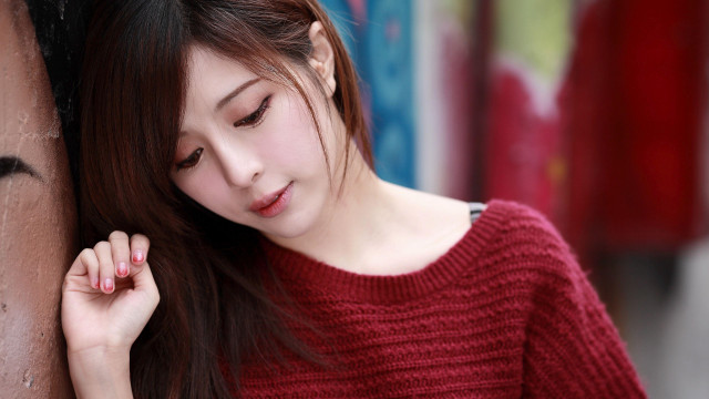 Woman leaning wall hand head #3 free wallpaper - medium preview image