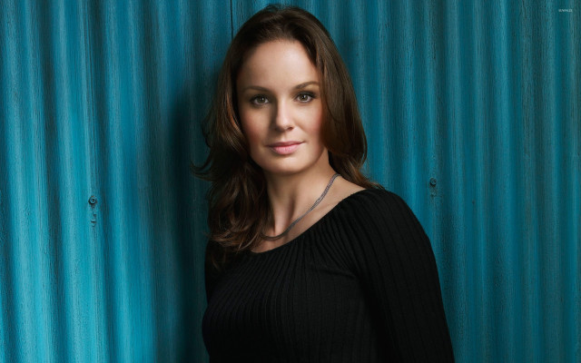 Woman black top blue wall free wallpaper - medium preview image