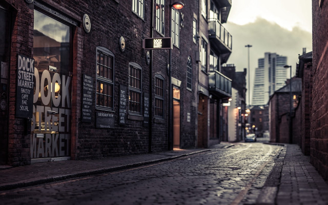 Narrow street brick building clock free wallpaper - medium preview image