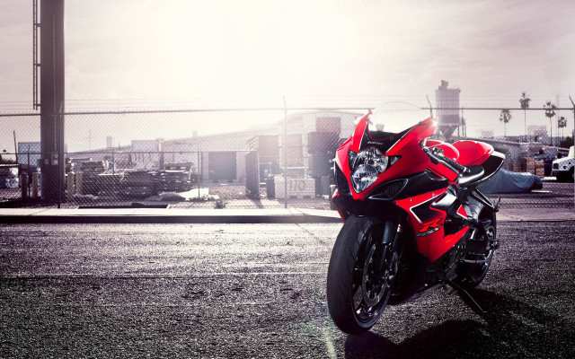 Red motorcycle parked road fence free wallpaper - medium preview image