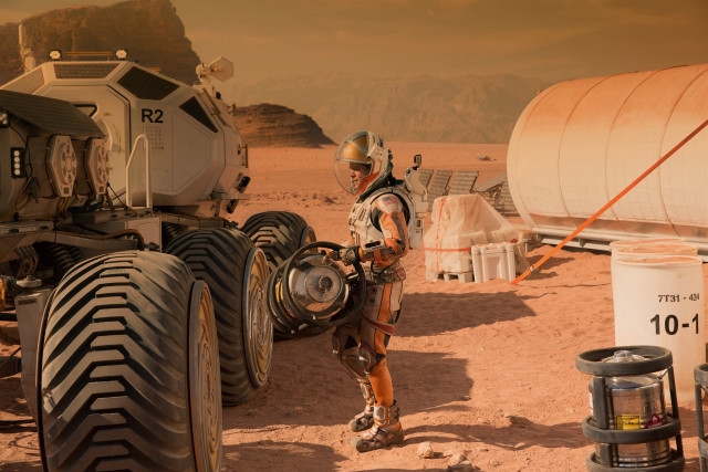 Man space suit large tire free wallpaper - medium preview image