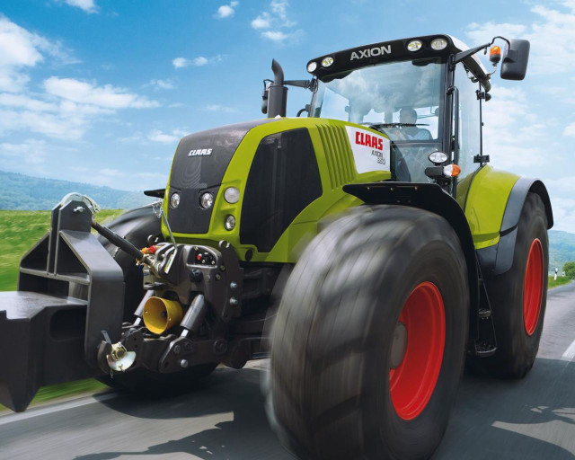 Tractor driving road sky background free wallpaper - medium preview image