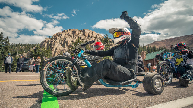 Man motorcycle helmet wheelie parade free wallpaper - medium preview image