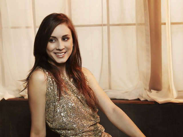 Woman gold dress couch smiling free wallpaper - medium preview image
