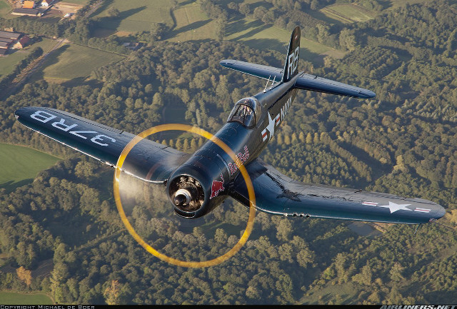 Airplane flying forest hillside yellow free wallpaper - medium preview image
