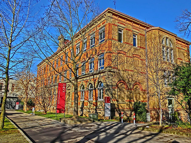 Large brick building red door free wallpaper - medium preview image