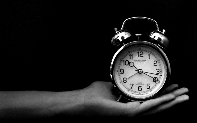 Person holding alarm clock dark #2 free wallpaper - medium preview image