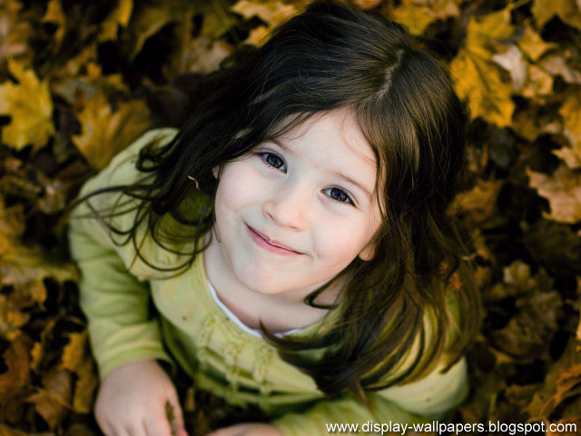 Little girl smiling leaves ground #2 free wallpaper - medium preview image