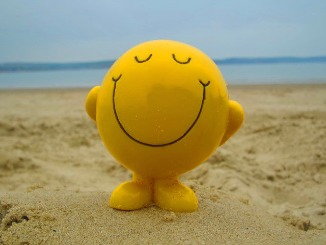 Yellow smiley face toy sand free wallpaper - medium preview image