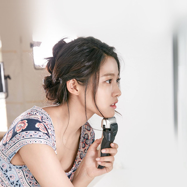 Woman holding hair dryer mirror free wallpaper - medium preview image