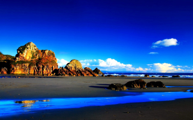 Beach blue water rocks sky free wallpaper - medium preview image