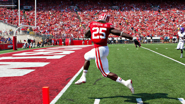 Football player running field crowd free wallpaper - medium preview image