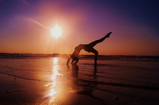 Handstand beach sunset sunshine silhouette free wallpaper - medium preview image