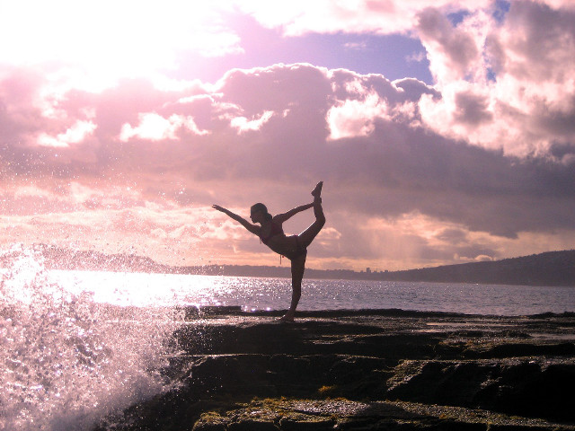 Woman yoga pose rocky beach free wallpaper - medium preview image