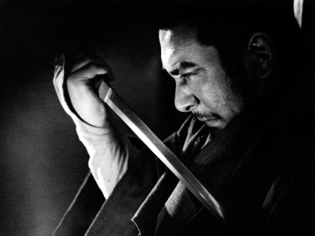 Man holding knife looking down free wallpaper - medium preview image