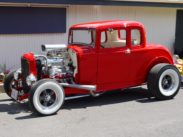Red car white building door free wallpaper - medium preview image