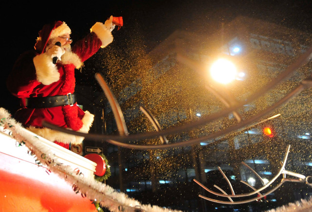 Santa claus waving crowd nighttime free wallpaper - medium preview image