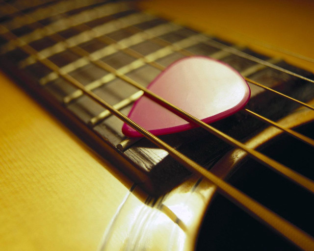Guitar pick on guitar strings free wallpaper - medium preview image