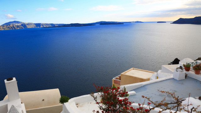 Hilltop house bushes water beach free wallpaper - medium preview image