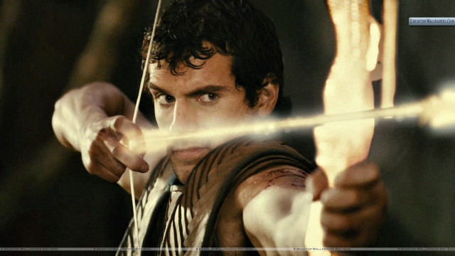 Man holding bow arrow blurry free wallpaper - medium preview image