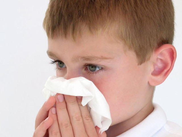 Young boy blowing nose napkin free wallpaper - medium preview image