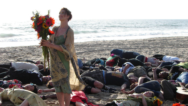 Woman holding flowers beach group free wallpaper - medium preview image
