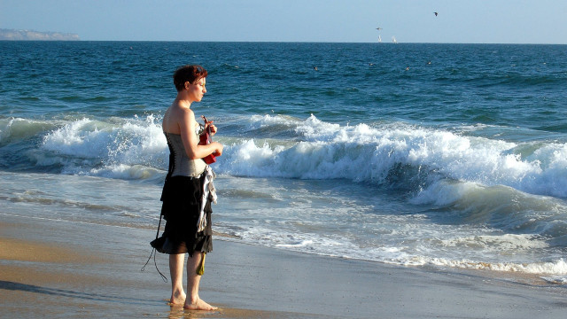 Man beach ocean cellphone microphone free wallpaper - medium preview image