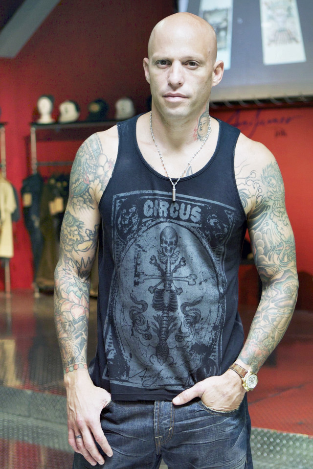 Bald tattooed man red wall free wallpaper - medium preview image