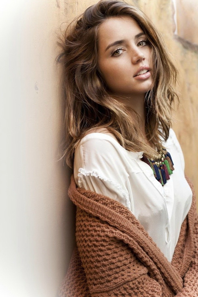 Woman leaning wall sweater necklace free wallpaper - medium preview image
