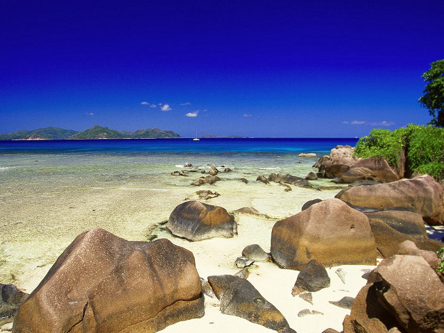 Beach rocks water boat sky free wallpaper - medium preview image