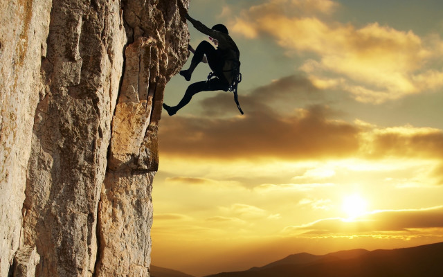 Man climbing cliff sunset backpack free wallpaper - medium preview image
