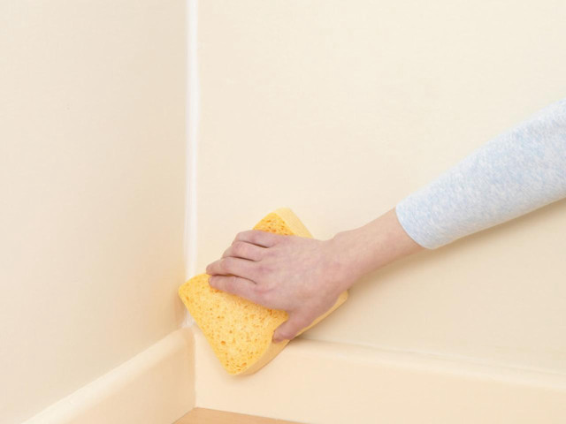 Person cleaning corner wall sponge free wallpaper - medium preview image