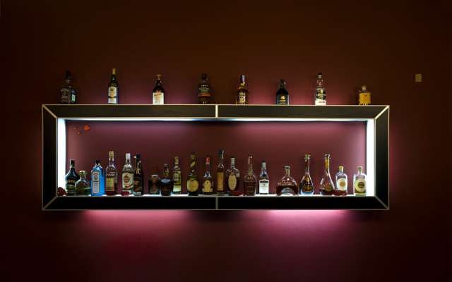 Shelf liquor bottles red wall free wallpaper - medium preview image