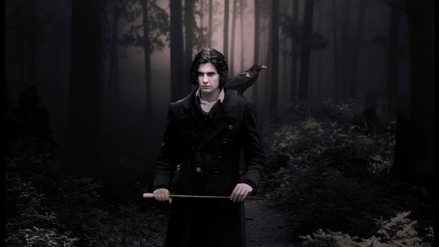 Man long coat holding stick free wallpaper - medium preview image
