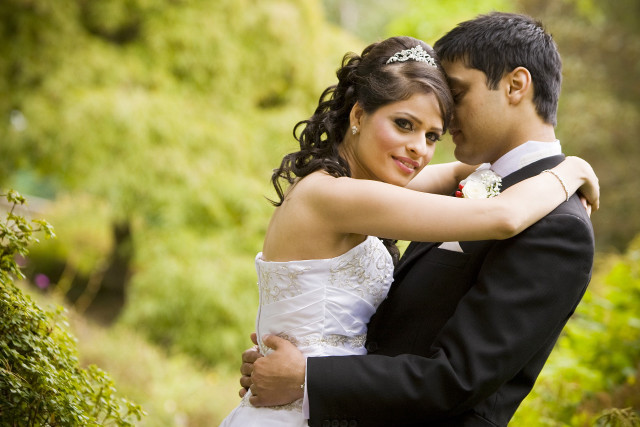 Bride groom embracing garden bushes free wallpaper - medium preview image