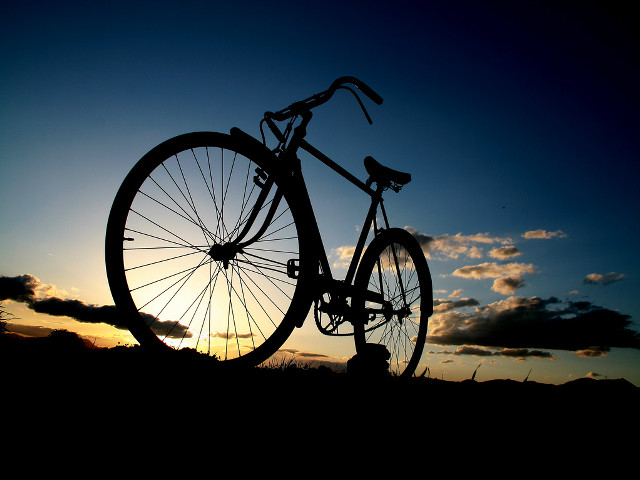 Bike parked grass sunset sun free wallpaper - medium preview image