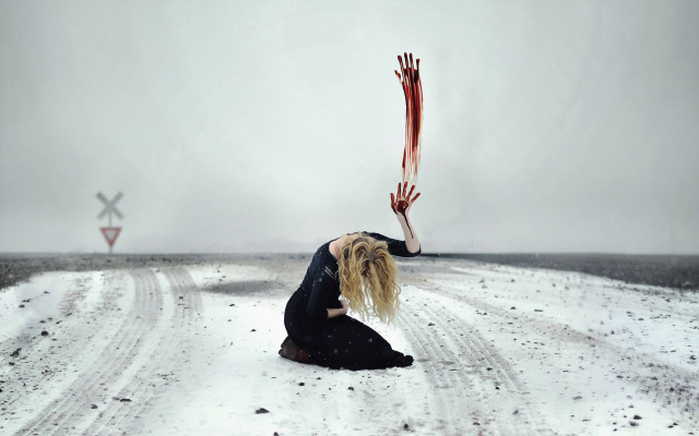 Woman kneeling snowy road holding free wallpaper - medium preview image