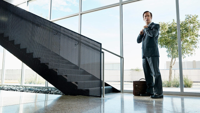 Man standing staircase building suitcase free wallpaper - medium preview image