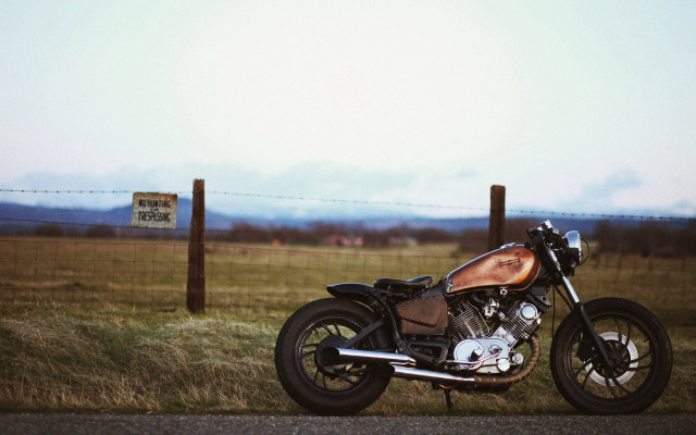 Motorcycle parked road fence field free wallpaper - medium preview image