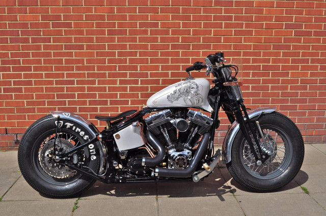 Motorcycle parked brick wall sidewalk free wallpaper - medium preview image