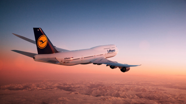Large jetliner mountain sunset backlit free wallpaper - medium preview image