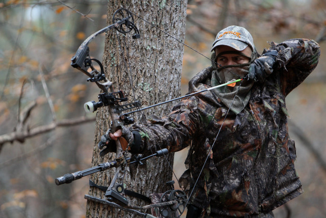 Man holding bow aiming arrow #2 free wallpaper - medium preview image