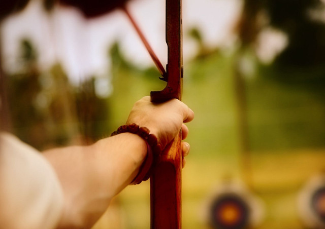 Person holding pole green field free wallpaper - medium preview image