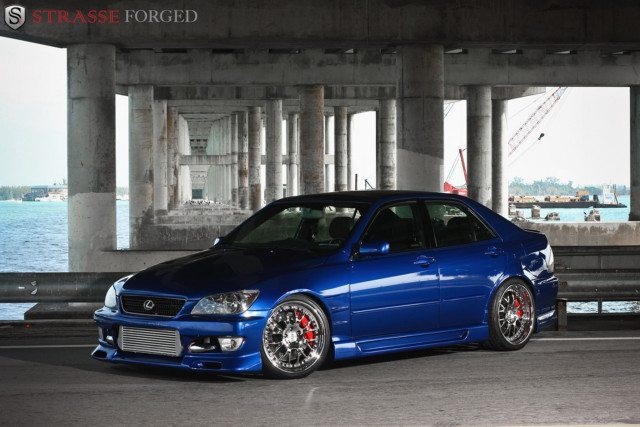 Blue car parked bridge water free wallpaper - medium preview image