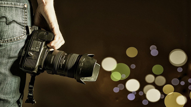 Person holding camera blurry background #3 free wallpaper - medium preview image